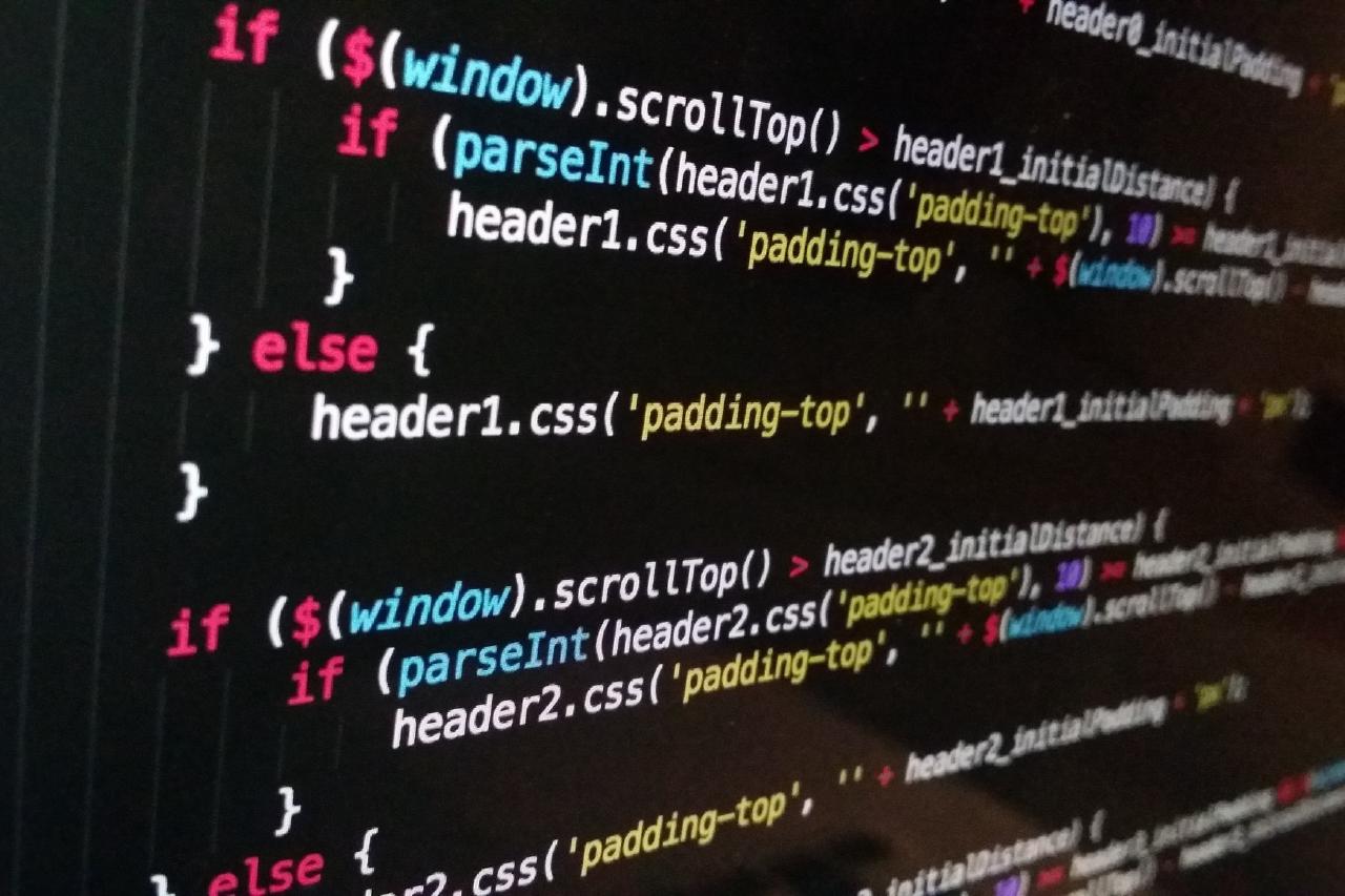 Photo of web development code on a partially visible screen